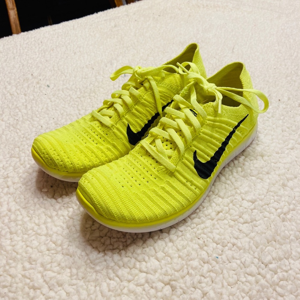 Nike Free RN Flyknit neon yellow running shoe.